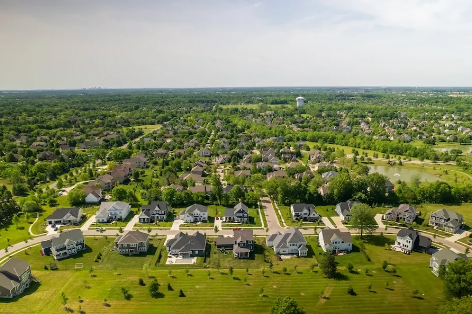 Aerial view of suburban neighborhood with large houses and green grass near Columbus, Ohio.